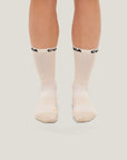 Model wearing Cuera 2-Pack Grip Socks in Sand, front studio view
