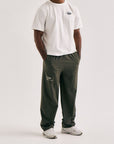 Model wearing Cuera Active Cuera Track Pants in Army, front studio view