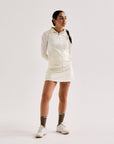 Model wearing Cuera Active Cuera Zip Cardigan in Off White, front studio view