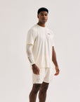 Model wearing Cuera Active Light Weight T-Shirt in Off White/Walnut, front studio view