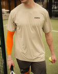 Model wearing Cuera Active Light Weight T-Shirt in Sand, front studio view