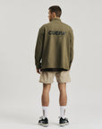 Model wearing Cuera Active Structure Half Zip in Army, back studio view