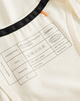 Cuera Oncourt Cuera Airy Tank Top in Off White, neck label and care tag detail