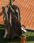Model with Cuera Oncourt Premium Padel Bag in Walnut, lifestyle action shot on the padel court