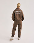 Model wearing Cuera Offcourt Cuera Half Zip Sweat in Walnut, back studio view