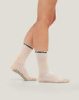 Model wearing Cuera 2-Pack Grip Socks in Sand, front studio view
