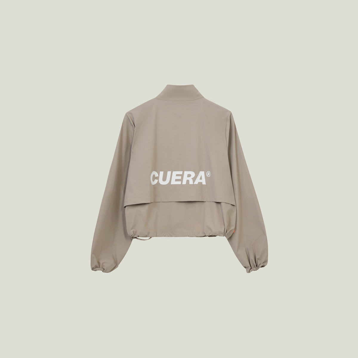 Model wearing Cuera Active Cuera Short Jacket in Taupe, front studio view