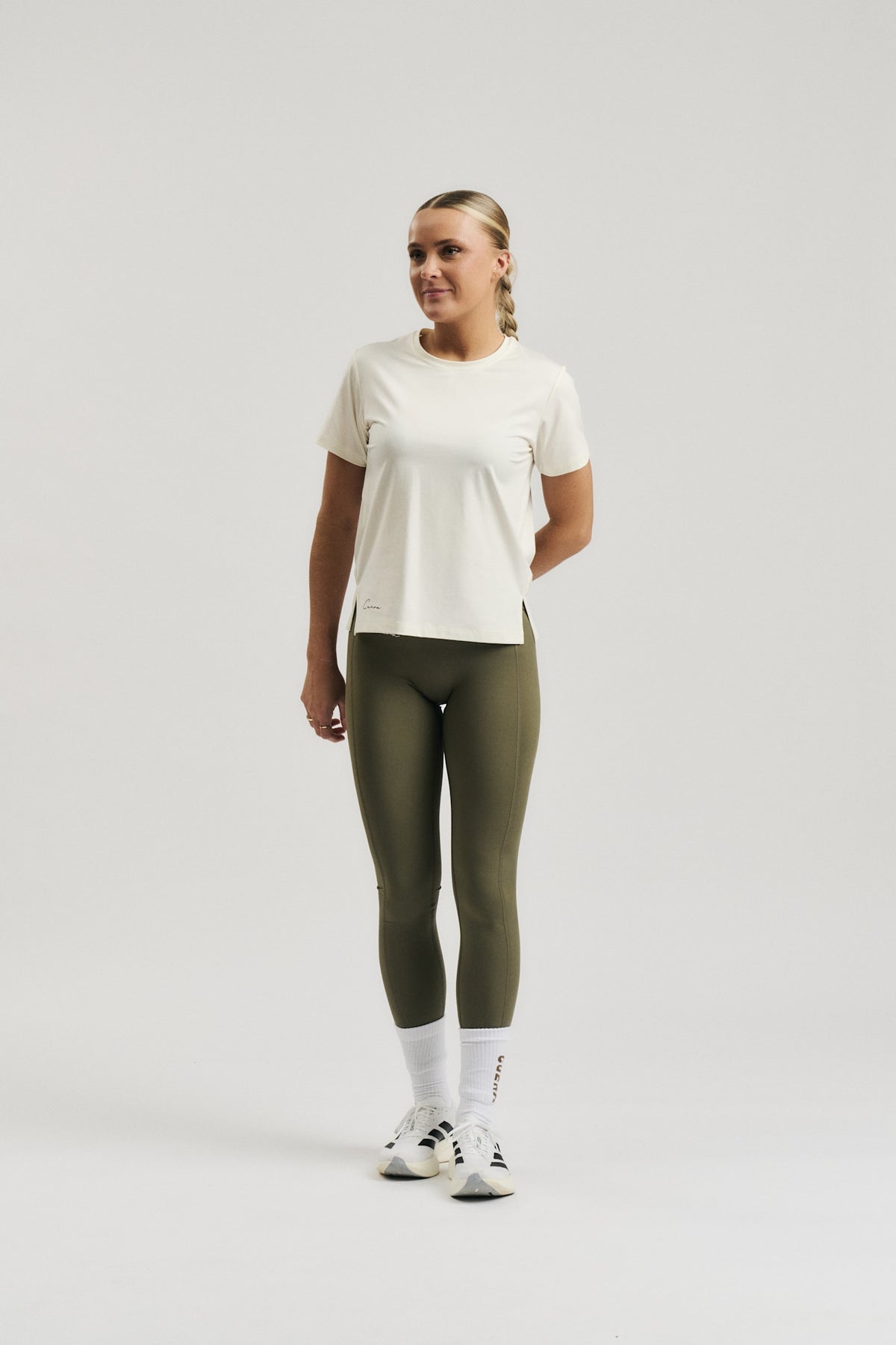 Model wearing Cuera Active Cuera Tights Hidden Front Seem in Army, front studio view