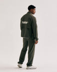 Model wearing Cuera Active Cuera Track Pants in Army, front studio view
