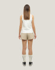 Woman wearing Cuera Womens Active Globe Shorts in Sand, back studio view