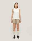 Woman wearing Cuera Womens Active Globe Shorts in Sand, front studio view