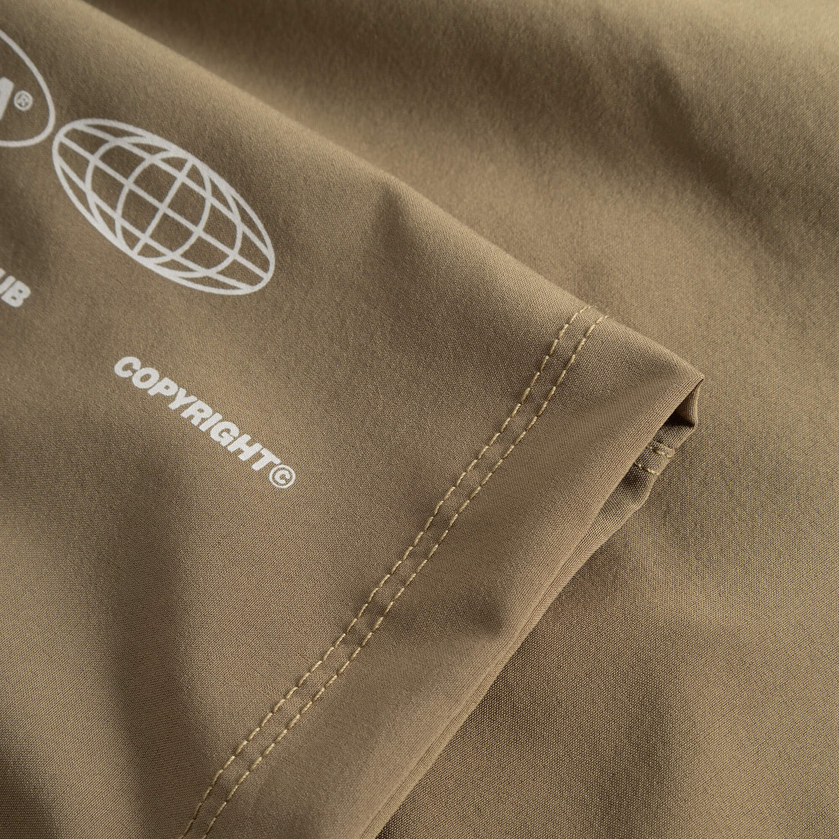 Cuera Womens Active Globe Shorts in Walnut, logo print detail