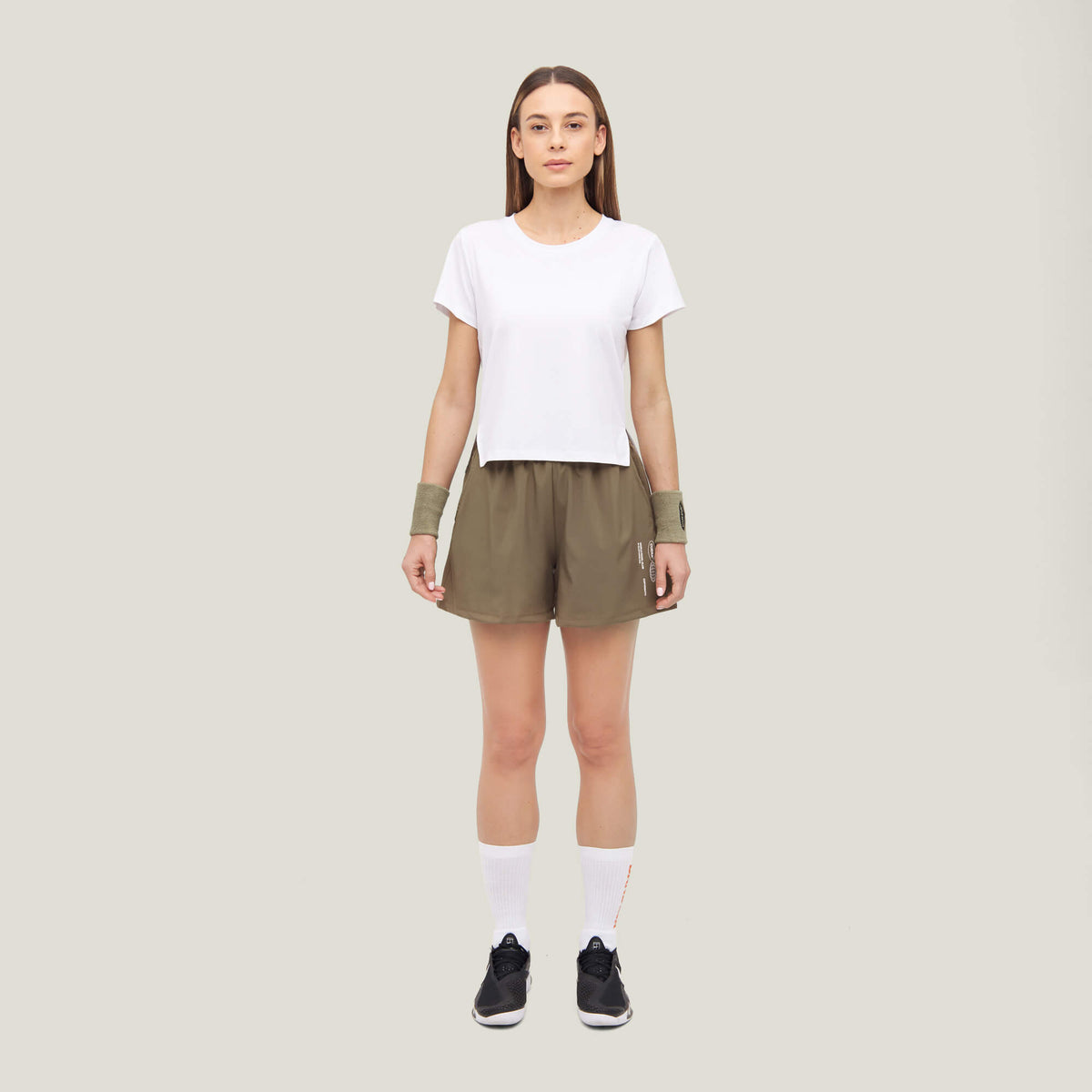 Woman wearing Cuera Womens Active Globe Shorts in Walnut, front studio view