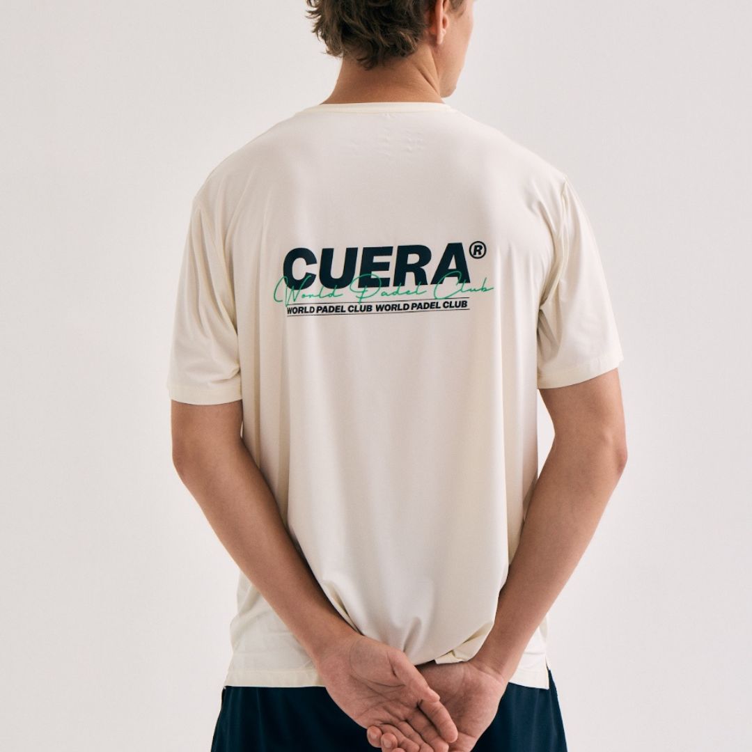 Model wearing Cuera Active Light Weight T-Shirt in Off White w. Navy/Green, back studio view