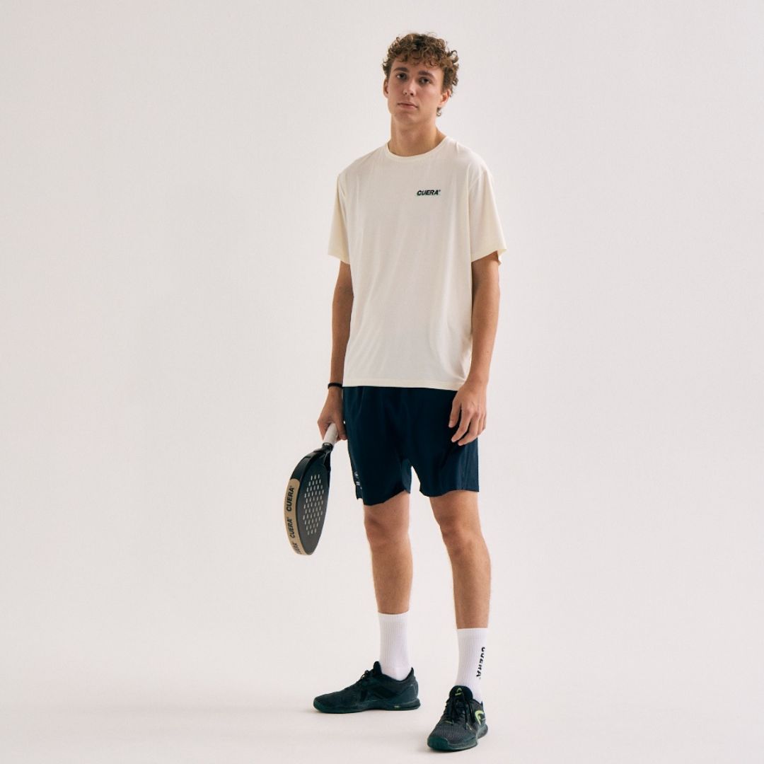 Model wearing Cuera Active Light Weight T-Shirt in Off White w. Navy/Green, front studio view