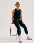 Model wearing Cuera Active Logo Tights Long in Black, front studio view