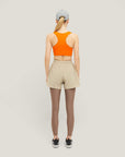 Woman wearing Cuera Active Made Bra in Orange, back studio view