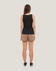 Model wearing Cuera Active Rib Tank Top in Black, back studio view