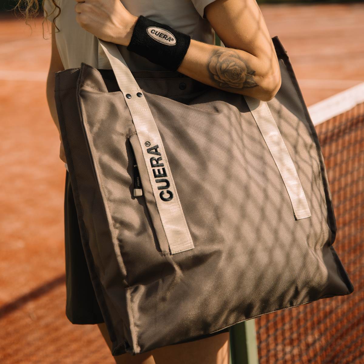Model with Cuera Active Totebag in Walnut, lifestyle action shot on the padel court
