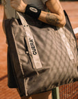 Model with Cuera Active Totebag in Walnut, lifestyle action shot on the padel court