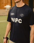 Model wearing Cuera Active WPC Light Weight T-Shirt in Navy, front studio view