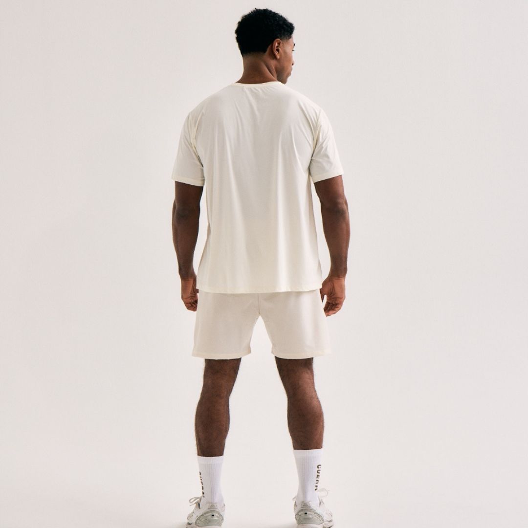 Model wearing Cuera Active WPC Light Weight T-Shirt in Off White/Walnut, back studio view