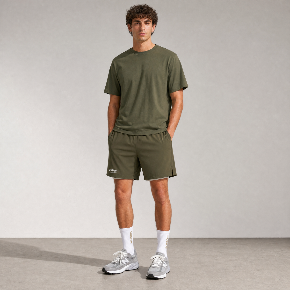 Model wearing Cuera Breathe Active Unifrom in Army, front studio view