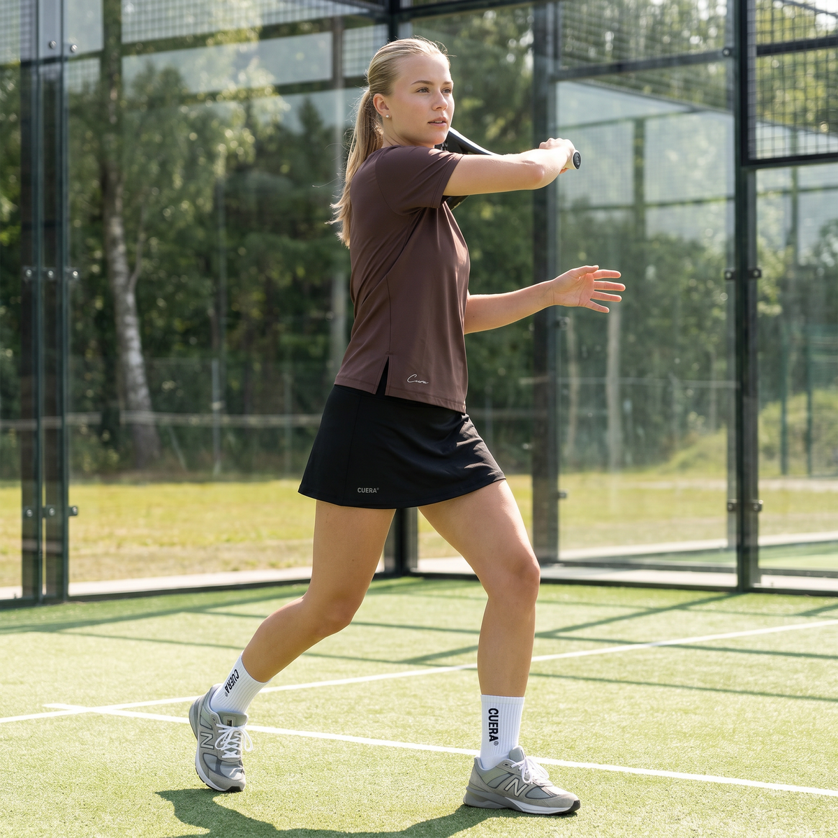 Model wearing Cuera DM2026 in Julia Wiese, lifestyle action shot on the padel court