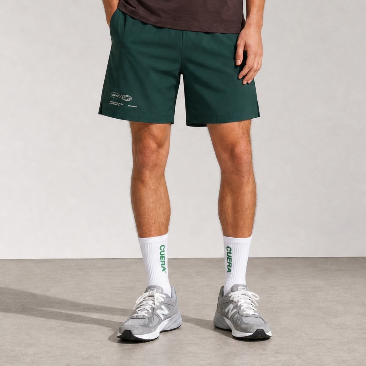 Model wearing Cuera Green shorts & 2-pack socks, front studio view