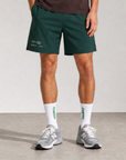 Model wearing Cuera Green shorts & 2-pack socks, front studio view