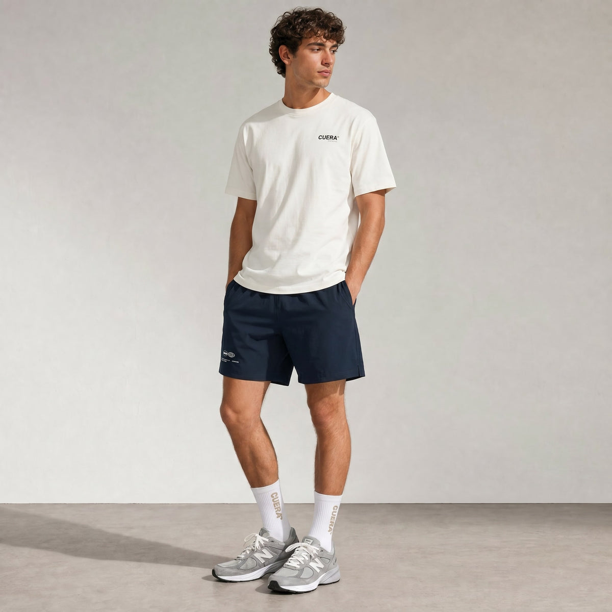 Man wearing Cuera Mens Active Globe Shorts in Navy, front studio view