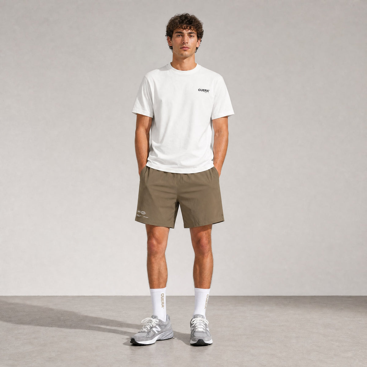 Man wearing Cuera Mens Active Globe Shorts in Walnut, front studio view