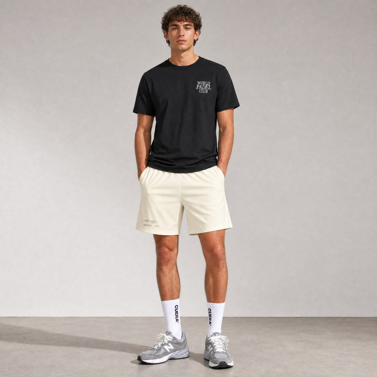Man wearing Cuera Mens Active Globe Shorts in Off White, front studio view