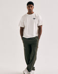 Model wearing Cuera Offcourt Legacy Short Sleeve in Off White w. Navy, front studio view