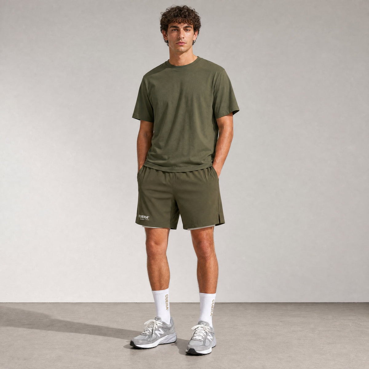 Model wearing Cuera Oncourt 2in1 Shorts in Army, front studio view