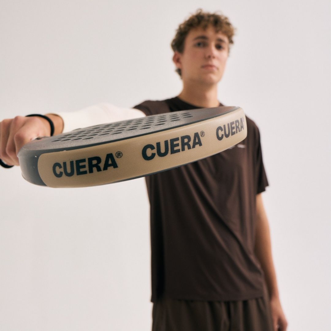 Model wearing Cuera Oncourt Airy Logo T-Shirt in Dark Brown, close-up detail on model
