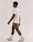 Model wearing Cuera Oncourt Airy Logo T-Shirt in Off White, lifestyle action shot on the padel court