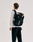 Model wearing Cuera Oncourt Bagpack small in Black, front studio view