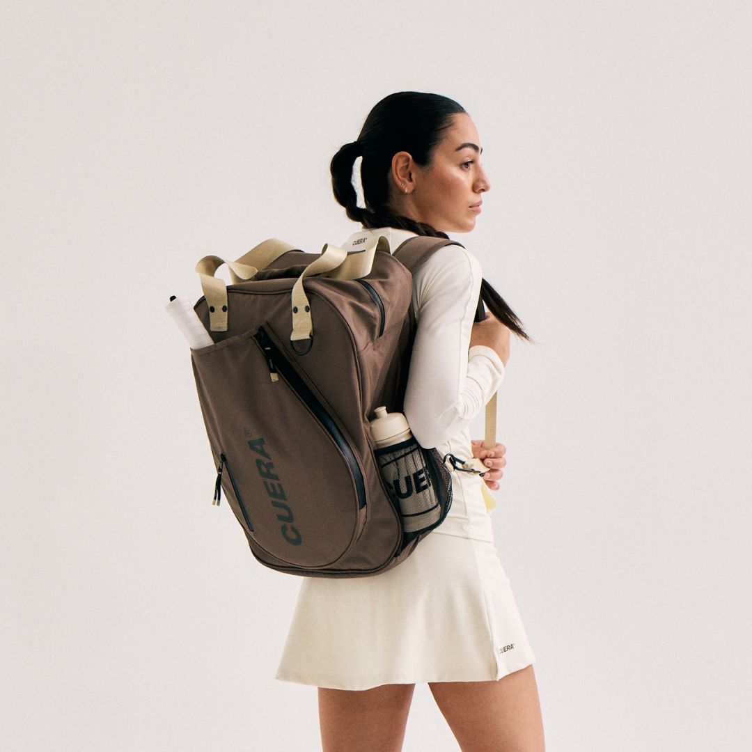 Model wearing Cuera Oncourt Bagpack small in Walnut, front studio view