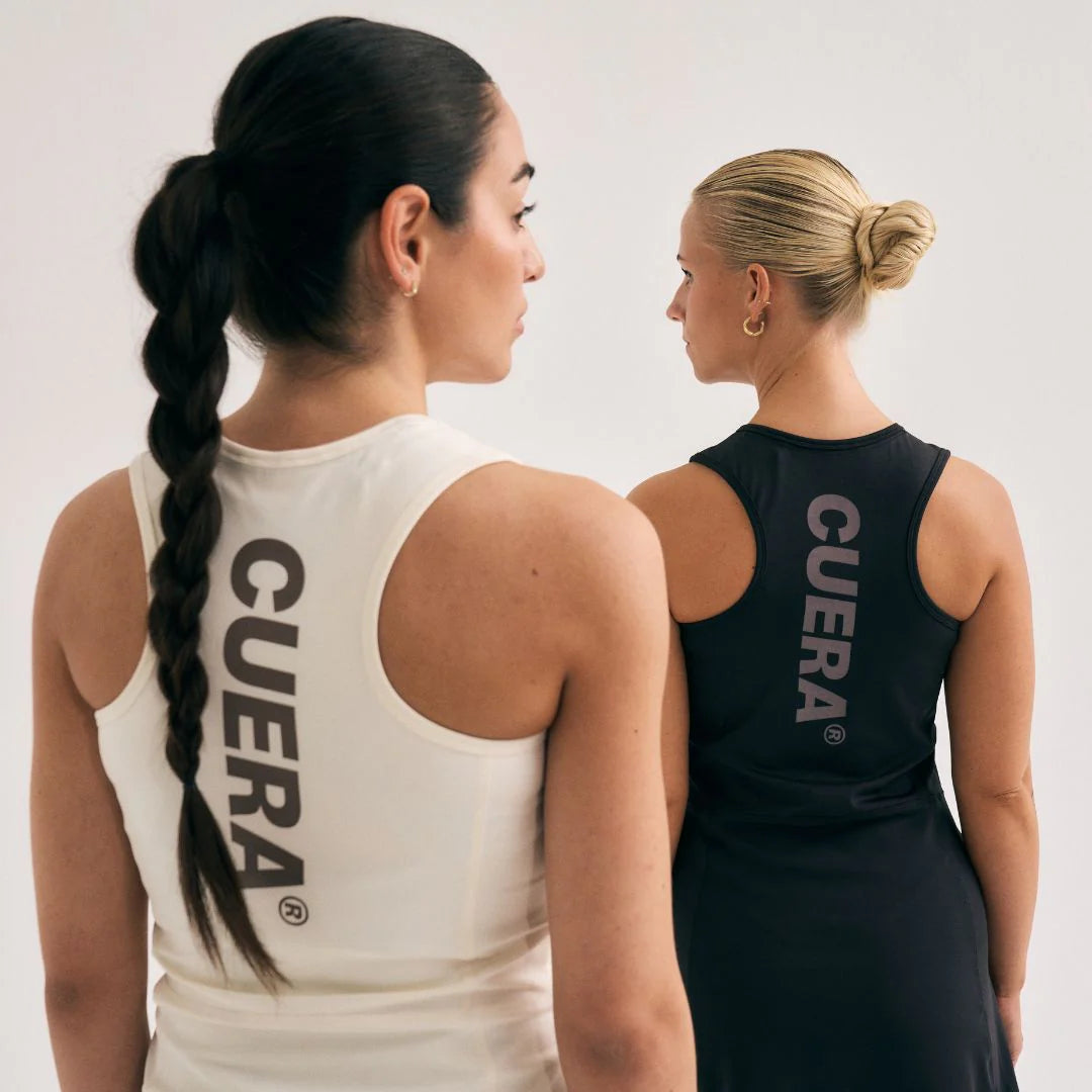 Model wearing Cuera Oncourt Black Dress Uniform, lifestyle action shot on the padel court