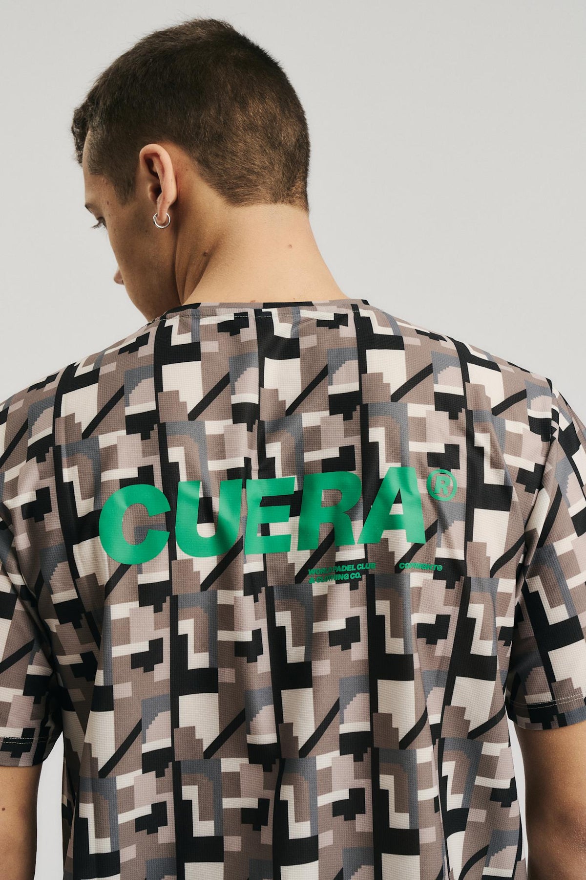 Model wearing Cuera Oncourt Breathe Camou T-Shirt in Camou Green Print, back studio view