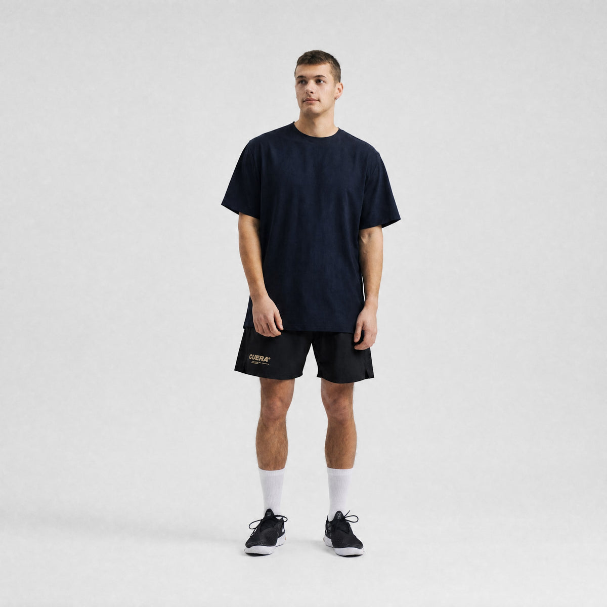 Model wearing Cuera Oncourt Breathe T-Shirt in Navy, front studio view