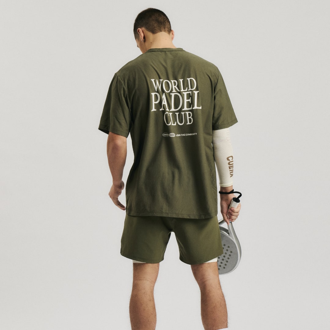 Model wearing Cuera Oncourt Breathe WPC T-Shirt in Army, lifestyle action shot on the padel court