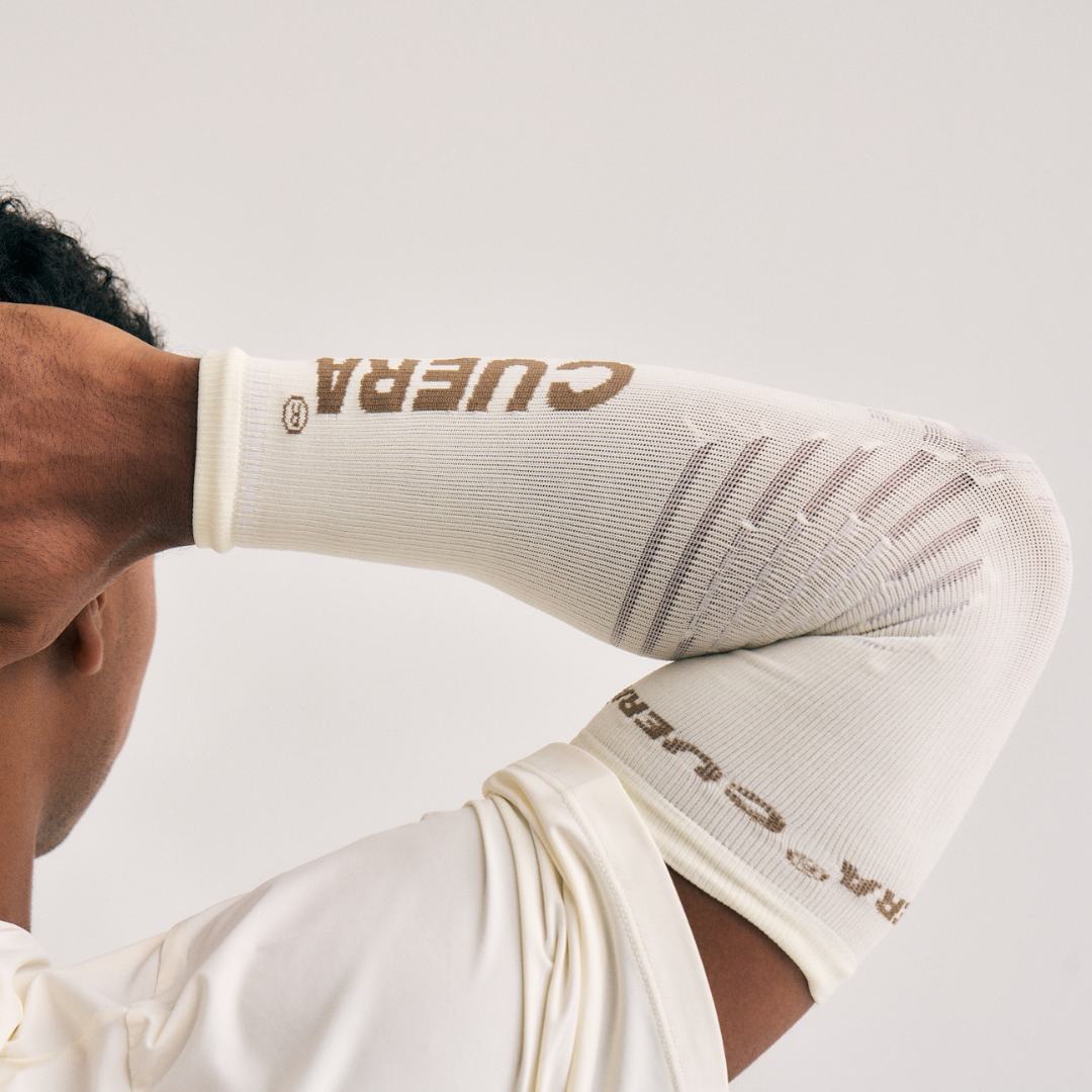 Model wearing Cuera Oncourt Compression Sleeve in Off White, close-up detail on model