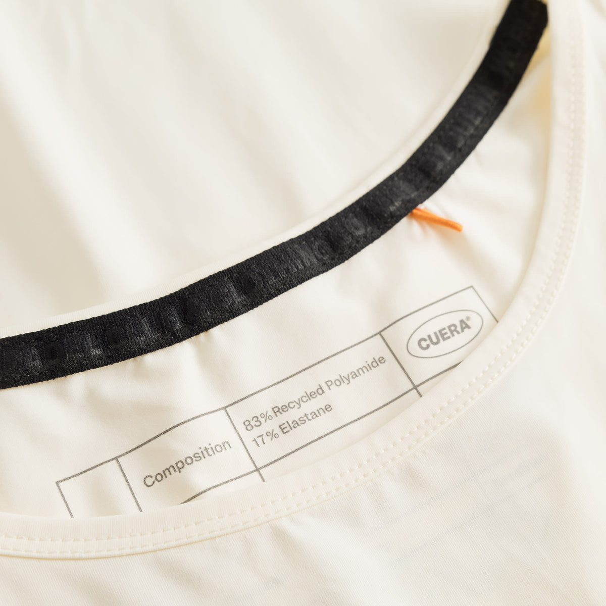 Cuera Oncourt Cropped Tank Top in Off White, neck label and care tag detail