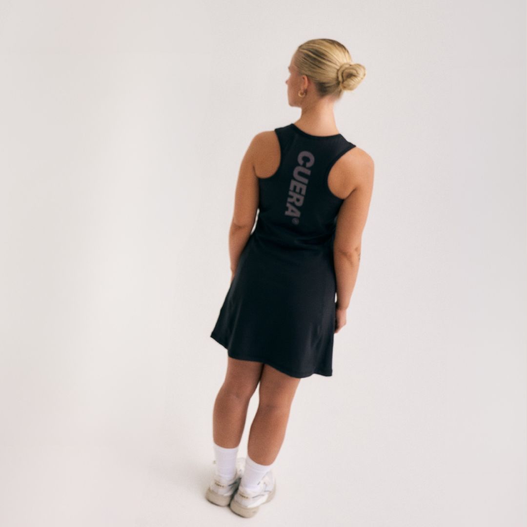 Model wearing Cuera Oncourt Cuera Dress in Black, back studio view