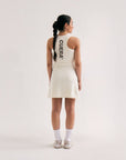 Model wearing Cuera Oncourt Cuera Dress in Off White, back studio view