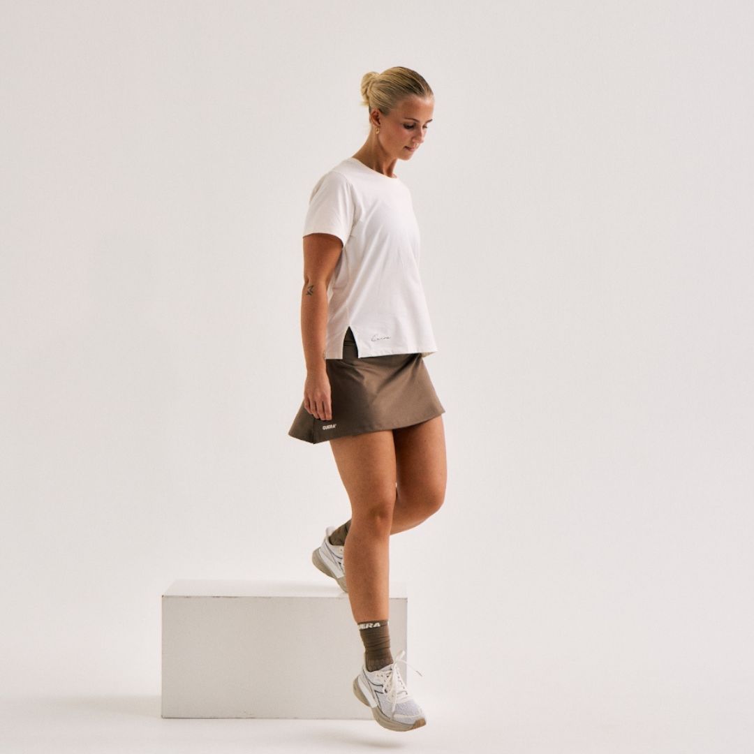 Model wearing Cuera Oncourt Cuera Skirt 2-in-1 in Walnut, front studio view