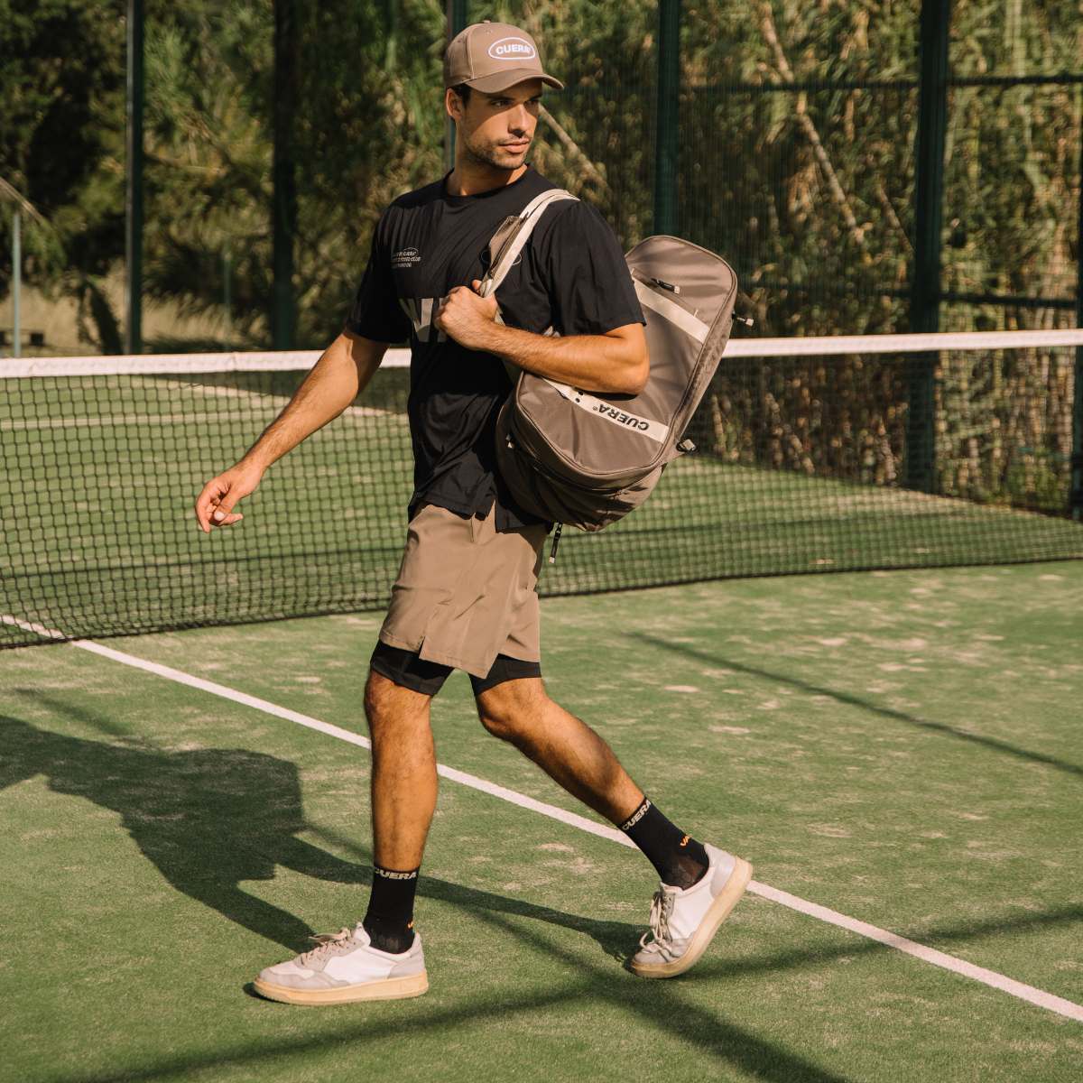 Model with Cuera Oncourt Premium Padel Bag in Walnut, lifestyle action shot on the padel court
