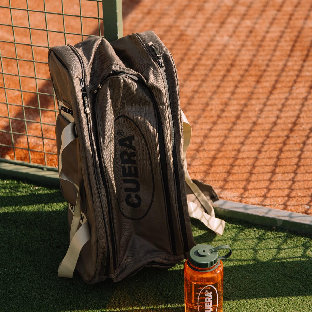 Model with Cuera Oncourt Premium Padel Bag in Walnut, lifestyle action shot on the padel court